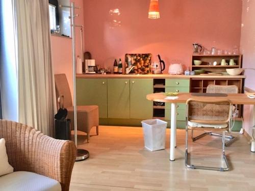 a kitchen with a table and a table and chairs at Guest Apartment Unterbach in Düsseldorf