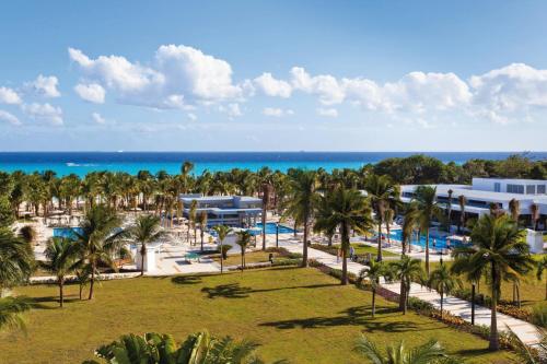 an aerial view of a resort with palm trees and the ocean at Riu Palace Mexico - All Inclusive in Playa del Carmen