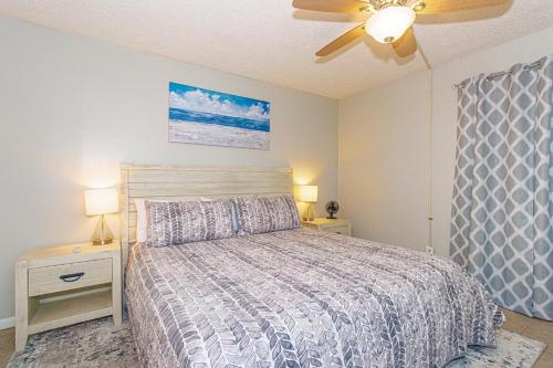a bedroom with a bed and a ceiling fan at Oceanfront 1 bedroom King suite- Ocean Forest Plaza 1911 in Myrtle Beach