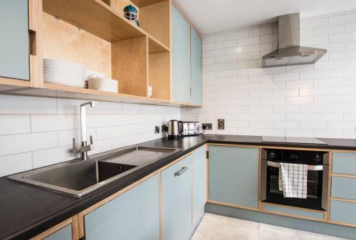a kitchen with a sink and a counter top at Modern City Centre Rooms in Dublin