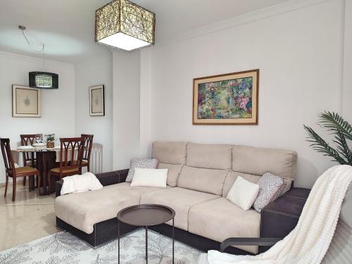 a living room with a couch and a table at Céntrico Apartamento Jardines de Vallellano in Córdoba