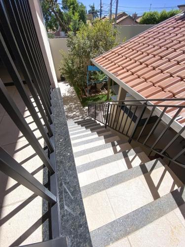 a staircase leading up to a house with a roof at Otimo apto com lazer e Wi-Fi em Campo Grande MS in Campo Grande