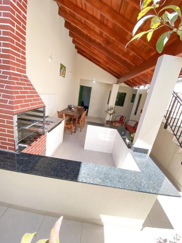 a living room with a fireplace and a table at Otimo apto com lazer e Wi-Fi em Campo Grande MS in Campo Grande