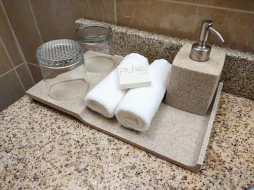 a bathroom sink with towels on a counter at Stars Inn and Suites - Hotel in Fort Saskatchewan