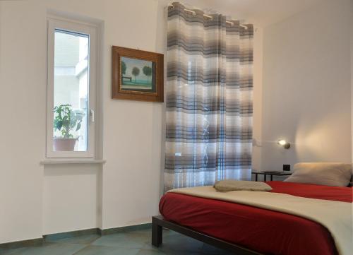 a bedroom with a bed and a window at ORTI19 in Maiori