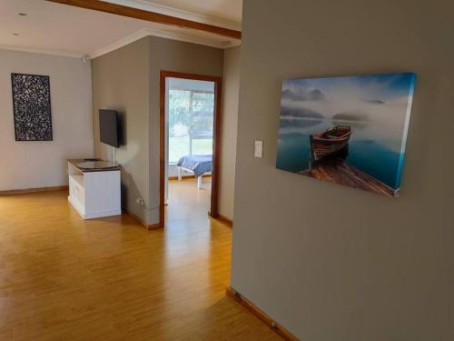 a living room with a large painting on the wall at Parsons Hill in Glendinningvale
