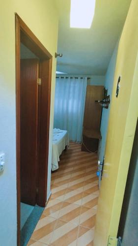 a hallway with a room with a bed and a door at Pousada Do Suiá in Arraial do Cabo