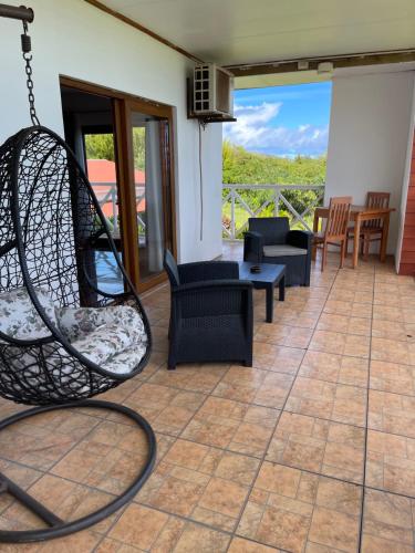 a patio with chairs and a swing at Teanehi Bed & Breakfast in Hanga Roa
