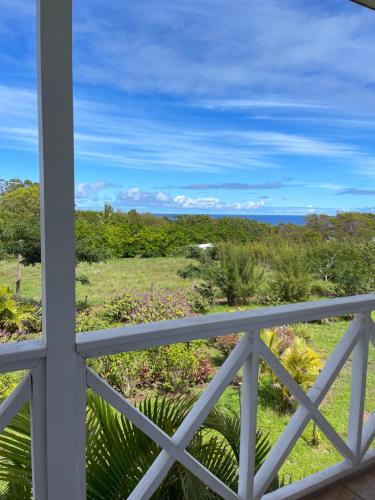 a view from a balcony of a field and trees at Teanehi Bed & Breakfast in Hanga Roa