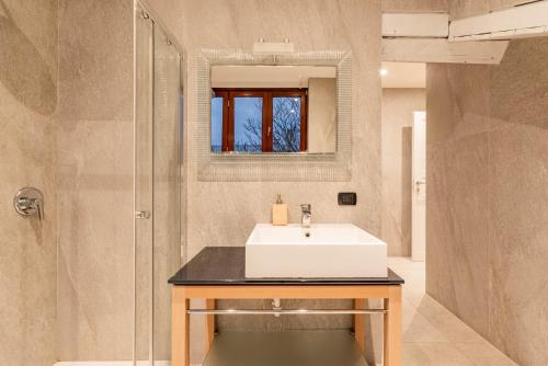 a bathroom with a sink and a shower at Brera Flat Near Duomo in Milan