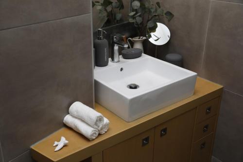 a bathroom with a white sink and a mirror at Casa Rosas do Mondego in Figueira da Foz