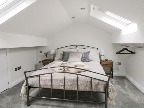 a bedroom with a bed in a white room at Moor View in Skipton
