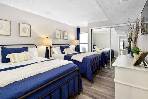 A bed or beds in a room at Ocean Front Sea Terrace 209 Heated Pool