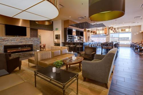 a lobby with couches and a fireplace and a bar at Delta Hotels by Marriott Saint John in Saint John