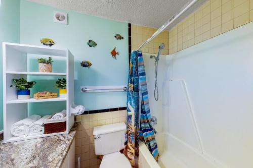 a bathroom with a toilet and a shower at The Top of the Gulf #612 in Panama City Beach