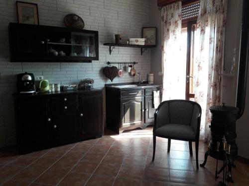 y cocina con fogones y silla. en Affittacamere B&B Caorso, en Caorso