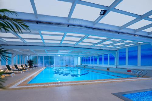 ein großer Pool in einem großen Gebäude in der Unterkunft Crowne Plaza Hotel & Suites Landmark Shenzhen, an IHG Hotel - Nearby Luohu Border, Indoor heated swimming pool, Receive RMB100 SPA coupon upon check-in in Shenzhen