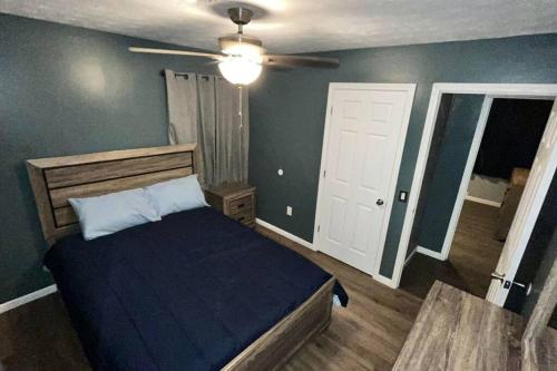 a bedroom with a bed and a ceiling fan at Quiet Getaway in La Follette