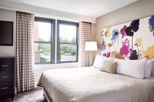 a bedroom with a large bed with a large window at The Raphael Hotel, Autograph Collection in Kansas City