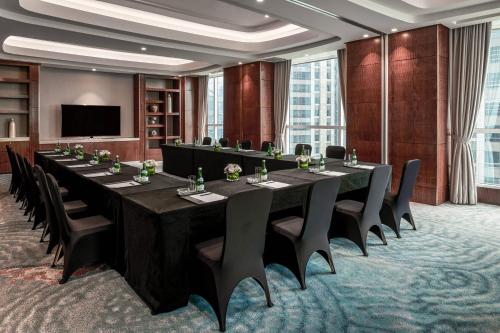 a large conference room with a long table and chairs at The Ritz-Carlton Jakarta, Pacific Place in Jakarta