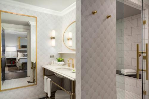a bathroom with a sink and a mirror at Hotel LeVeque, Autograph Collection in Columbus