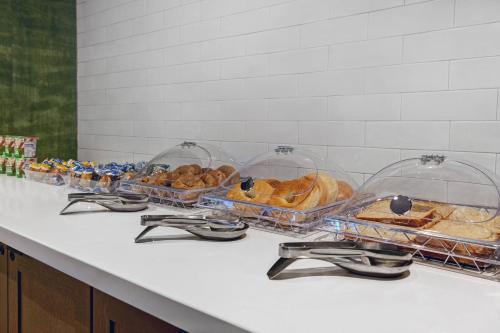 a counter with several trays of bread and pastries at Fairfield by Marriott Inn & Suites Denver Airport at Gateway Park in Denver