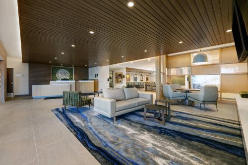 a living room with a couch and chairs on a rug at Fairfield by Marriott Inn & Suites Denver Airport at Gateway Park in Denver