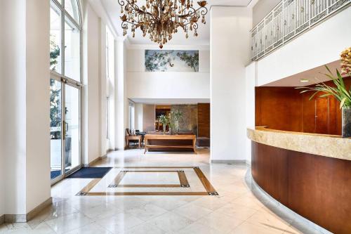 a lobby with a chandelier and a table at Marriott Executive Apartments Sao Paulo in São Paulo