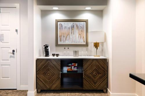 a room with a counter with a sink and a lamp at Ambassador Hotel Kansas City, Autograph Collection in Kansas City