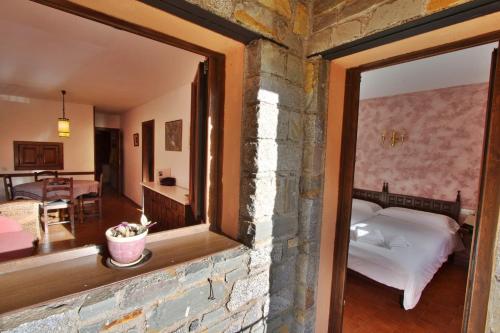 a room with a mirror and a bedroom with a bed at Apartaments la Peguera in Bohí