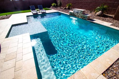 a swimming pool with blue water in a yard at Glamour Homes with balcony view, free champagne, parking next to major attractions in Bloomington