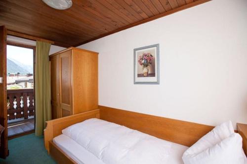 ein Schlafzimmer mit einem weißen Bett und einem Fenster in der Unterkunft Pension Katharina in Seeboden