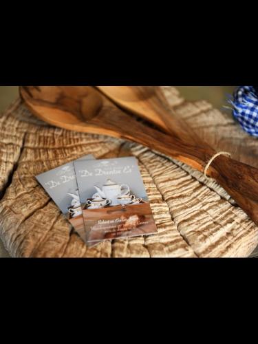 a book sitting on top of a table with a spoon at B&B De Drentse Es in Emmen