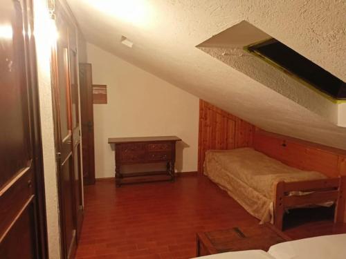 a bedroom with a bed and a wooden floor at Mansarda in Morgex
