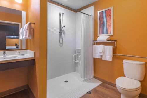 a bathroom with a shower and a toilet and a sink at TownePlace by Marriott Suites Gallup in Gallup