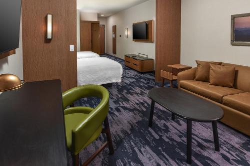a hotel room with a bed and a couch at Fairfield Inn & Suites by Marriott Menifee in Menifee