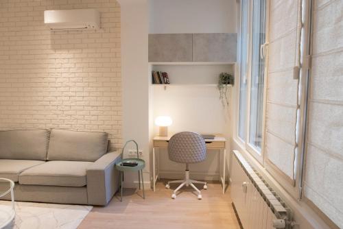 A seating area at Top Center Designer Studio Apartment