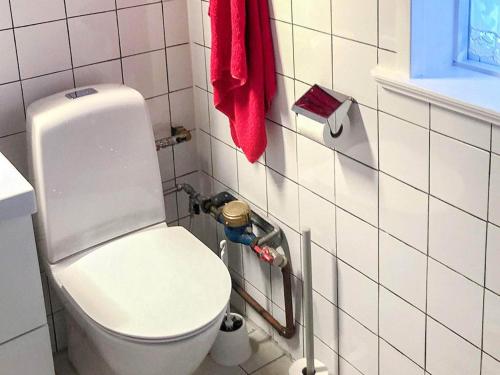 a bathroom with a white toilet and a red towel at Holiday home SILJANSNÄS in Siljansnäs