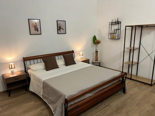 a bedroom with a large bed and two night stands at B&B Melissa in Noto