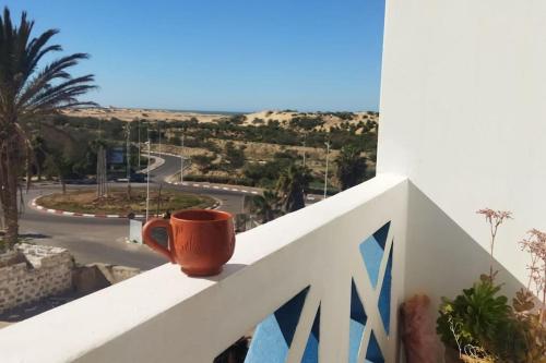 an orange coffee cup sitting on a white ledge at Lovers & Surfers Room - 5 min To Beach in Essaouira