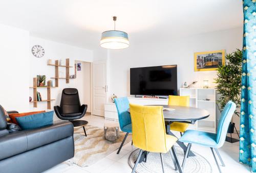 a living room with a table and chairs at Annecy Lake Central in Annecy