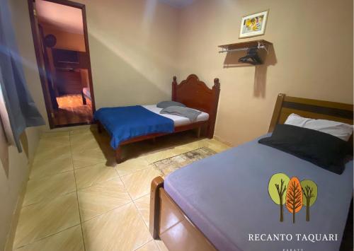 a bedroom with two beds and a mirror at Casa Sole & Mare - Praias e Cachoeiras in Paraty