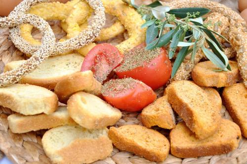 a plate of food with bread and tomatoes on it at Archontiko Art Hotel in Galaxidhion