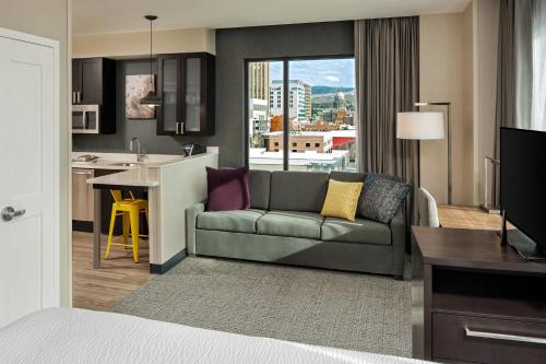 a living room with a couch and a kitchen at Residence Inn by Marriott Boise Downtown City Center in Boise