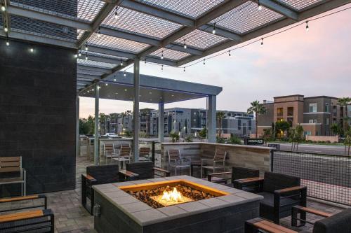 a patio with a fire pit and tables and chairs at SpringHill Suites by Marriott Riverside Redlands in Redlands