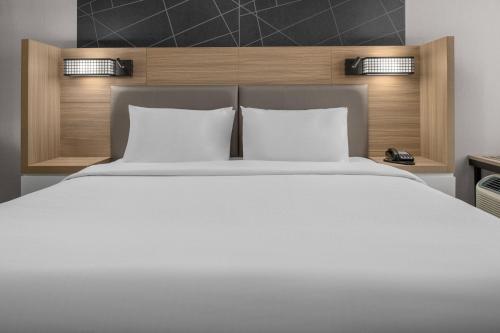 a bedroom with a large white bed with two pillows at SpringHill Suites by Marriott Riverside Redlands in Redlands