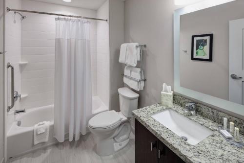 a bathroom with a toilet and a sink and a shower at TownePlace Suites by Marriott Orlando at SeaWorld in Orlando