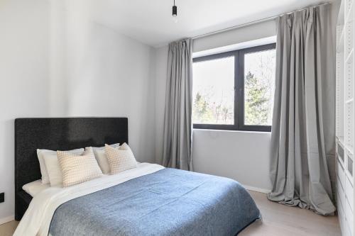 a bedroom with a bed and a large window at Stylish and spacious family home in Stockholm