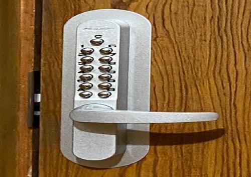 a white remote control attached to a wooden door at guest house goose - Vacation STAY 23621v in Hirosaki