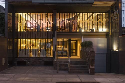a building with a staircase in front of a window at Arawi Miraflores Prime in Lima